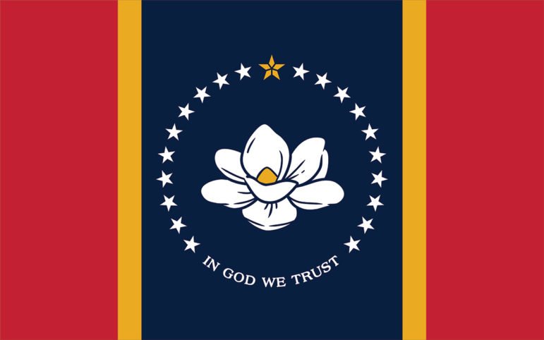 Mississippi state flag featuring a white magnolia flower encircled by stars on a blue field, flanked by red stripes and the text “In God We Trust.”