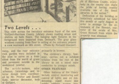 A newspaper clipping featuring a photograph of the two‑story entrance foyer of the Gulfport–Harrison County Library, showing bookshelves on both floors and large hanging light fixtures, accompanied by an article describing interior features such as reading areas, display spaces, children’s areas, and design elements.