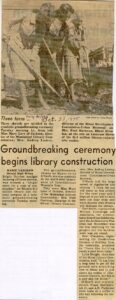 A newspaper clipping showing three people using shovels during a ceremonial groundbreaking for the new Biloxi library‑cultural center. The article describes the October 1975 event, noting participants, the symbolism of the ceremony, and details about the $1.6 million construction project.